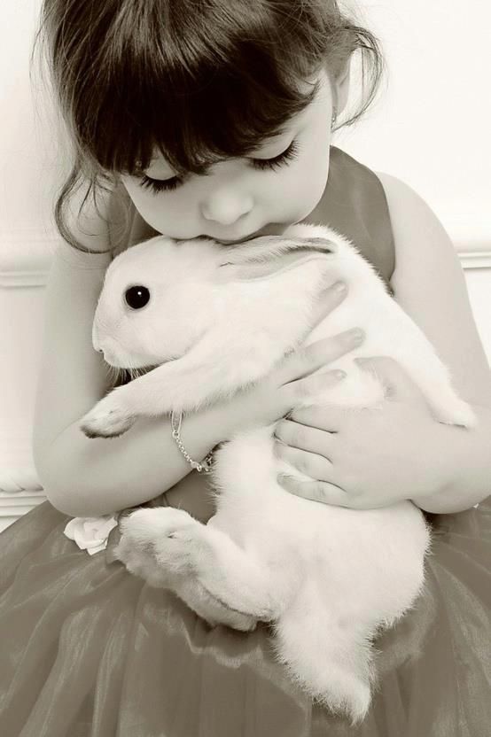 I have a photo of my son this age with his rabbit. Same pose. This is cute..