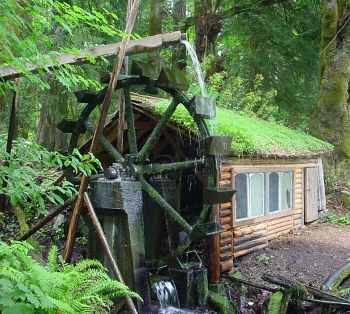 Small log cabin with water wheel – Off the Grid living