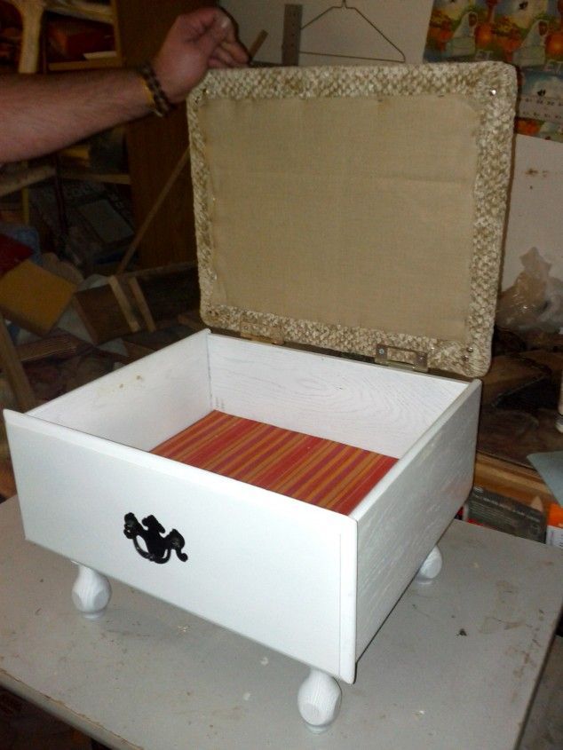 And legs to an old drawer, hinged lid with a padded top, and you have an ottoman