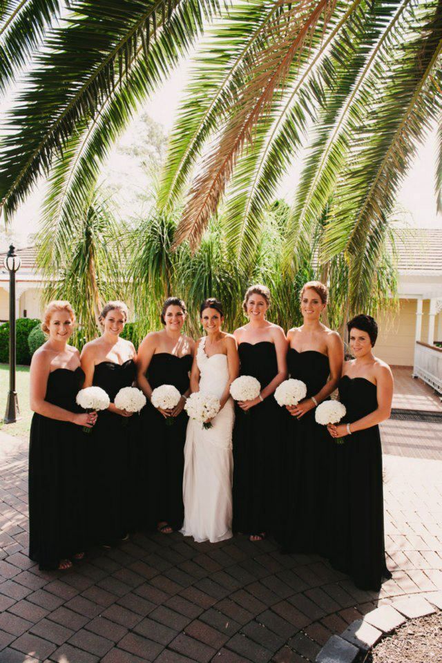 Black bridesmaid dresses with bright orange and pink flowers and shoes!