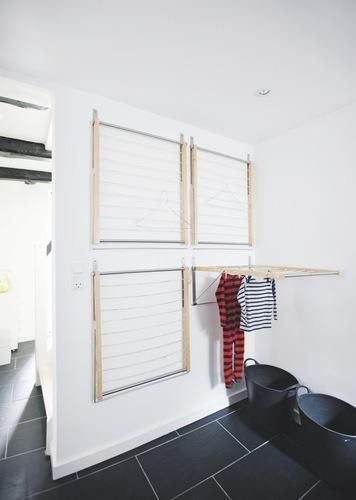 Four wall-mounted drying racks in a mudroom create an instant indoor drying room