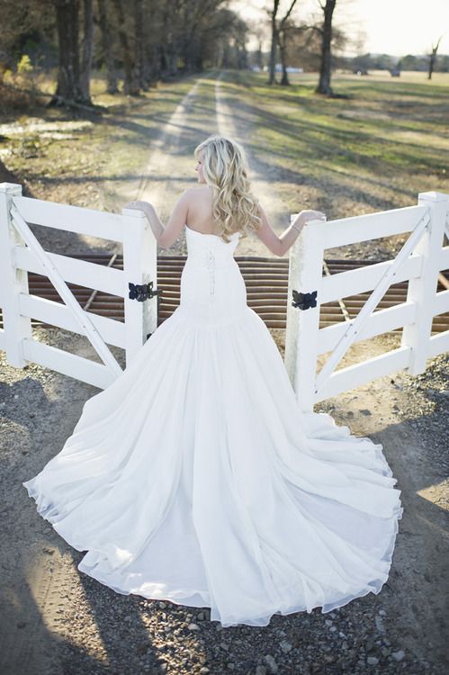 I love everything about this shot! The dress, the gate, the dirt road…