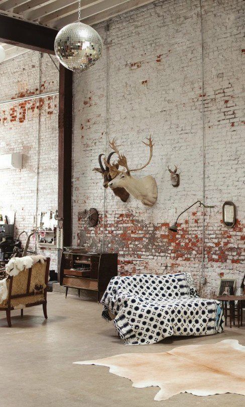 rustic industrial interior, hang all mounts and mst antlers on one recroom wall