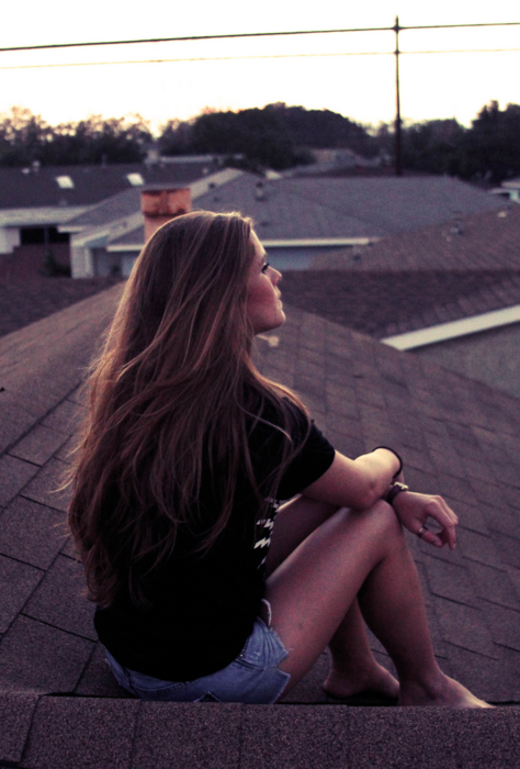 Sitting on the roof and thinking on a summer night. Watching the sun go down is