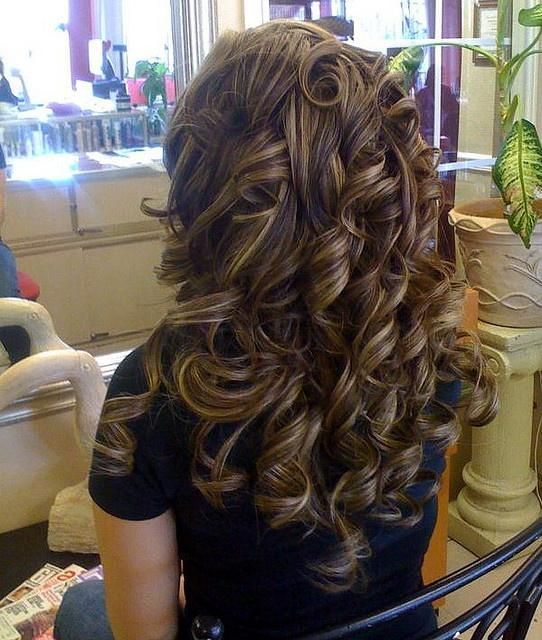 Thick curly brunette hair with caramel blonde low-lights