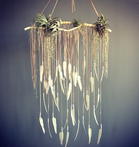 Wouldnt this be a cool backdrop for  a cake? Branch, hanging feathers and airlan
