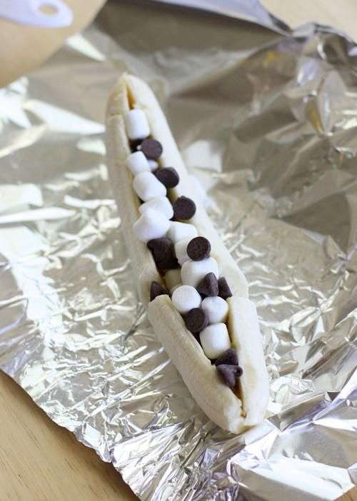 Slice a banana open , use any chocolate with marshmallows and bake until melted