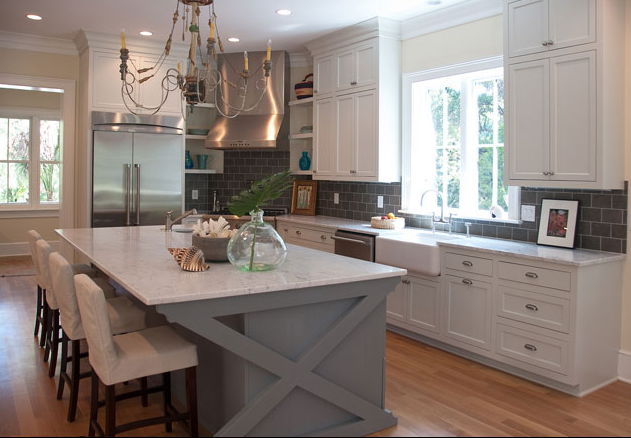 White kitchen with painted island… I like the charming cross beams on the isla