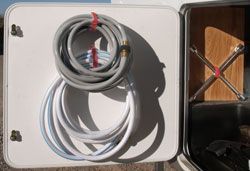 Hang coiled hoses from nylon velcro straps Tons of trailer organizing ideas