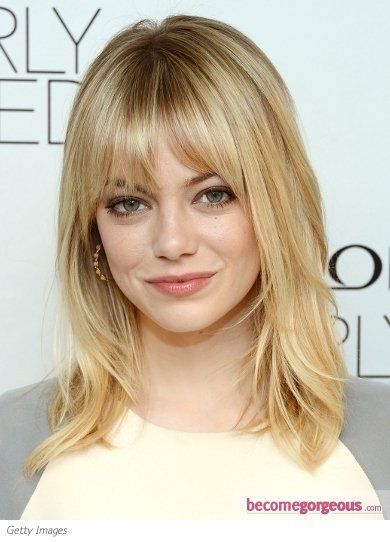 Emma Stone wears her shoulder-length medium hair with lots of face-framing layer