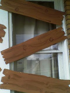Use cardboard and brown paint to make faux boards to board up windows- I think I