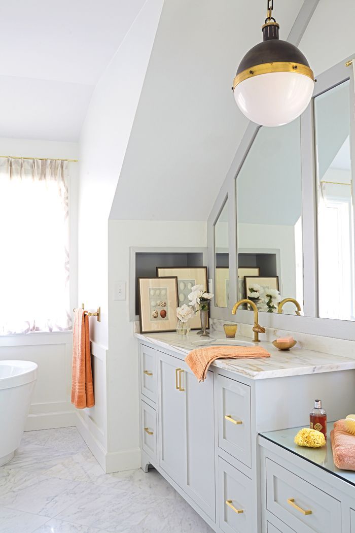Bright bathroom with brass fixtures and neutral painted cabinetry. #master #bath