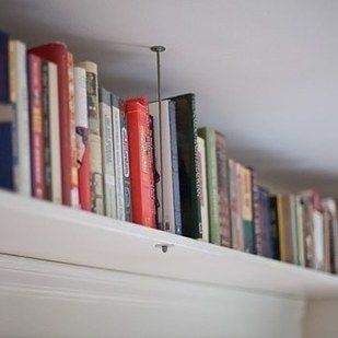Hang shelves near the ceiling to draw the eye upward. | 19 Foolproof Ways To Mak