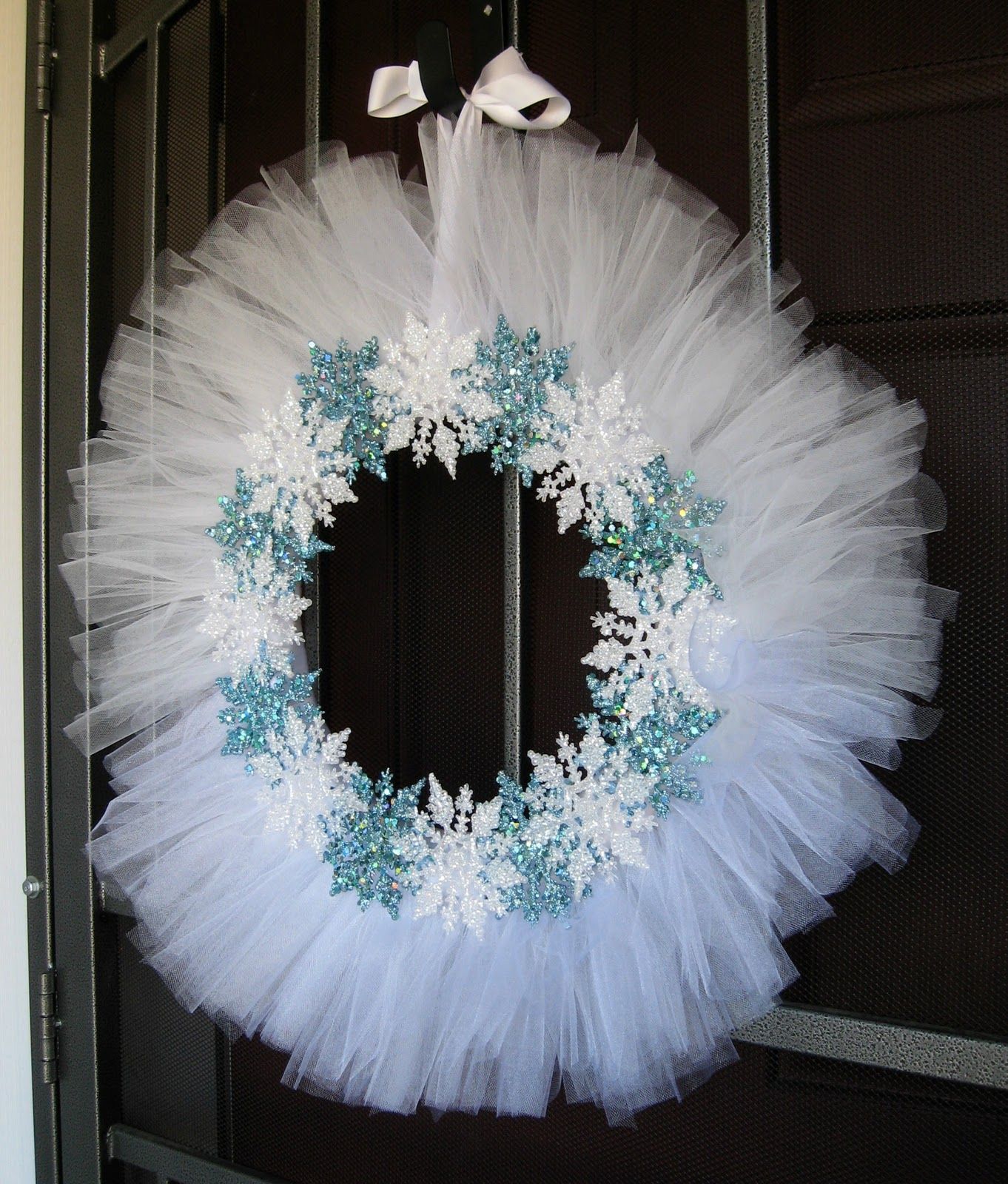 White tulle and snowflake wreath.  Love it!  I might have to do a blue tulle onl