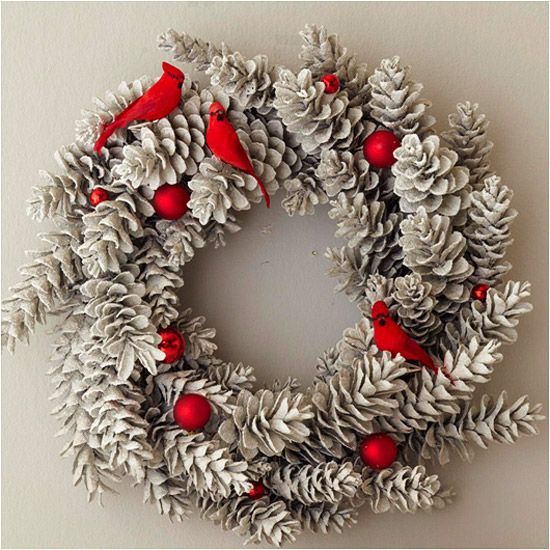 DIY pinecone wreath with cardinals and ornaments.