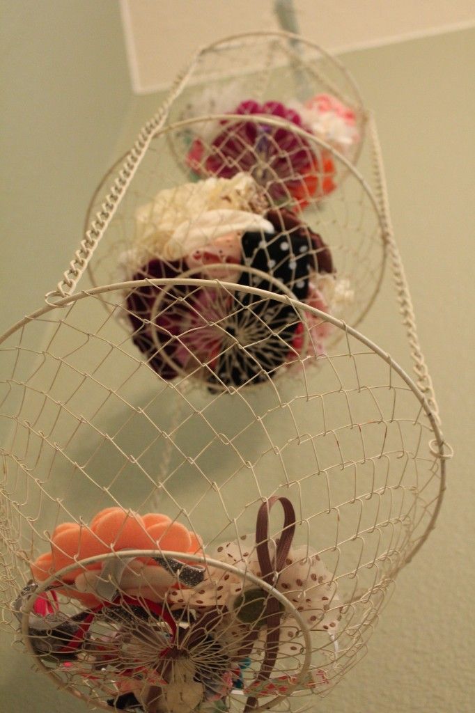 Cute idea on using a hanging fruit basket to hold hair accessories. Could work for stuffed animals