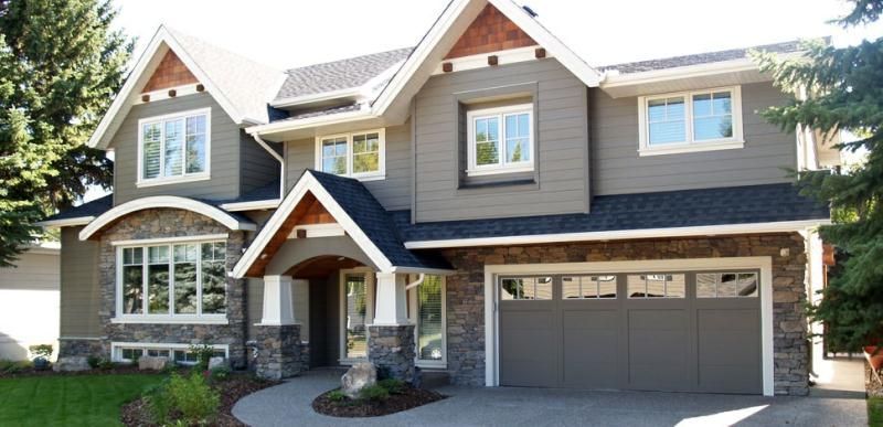 Dark Gray house with faux rock and Brown accents. White Trim!