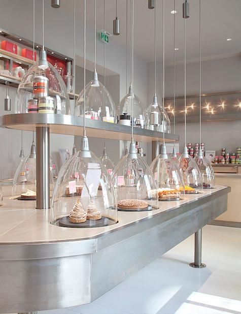 La Patisserie des Reves in Paris, Glass temperature controlled domes cover the cakes. The silver cylinder is the weight holding the cord in