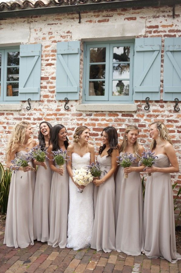 Love the nude bridesmaid dresses with the brick building and shutters behind it. The flowers look gorgeous with these