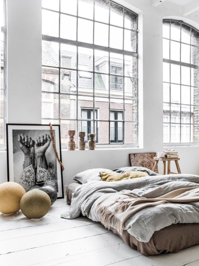 The dream flat set up – low to floor bed, large windows and oversized framed prints as