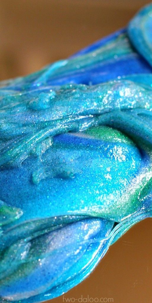 A recipe for super stretchy glitter slime that looks just like the ocean! Swirls of sensory and pretend play fun from