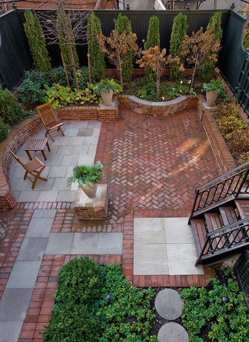Awesome brick & stone patio make incredible use of a small, enclosed yard space.  I would prefer if it was all brick, less distracting, and the space would feel