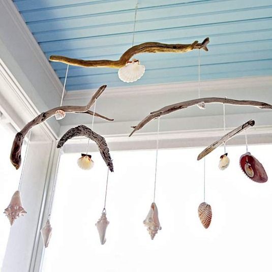Beach inspired decorating can be done in smaller or subtle ways by placing your coastal finds on display, such as this driftwood and shell mobile, or perhaps more simply and casually with starfish and
