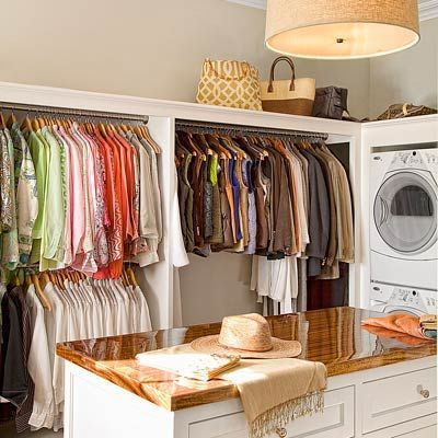 can you even imagine??? // Clean clothes go straight from the dryer to the drawer in this walk-in closet, no hamper required. Stacked machines and a built-in dresser that also serves as a folding