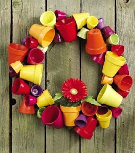 Decorate your outdoor space with a flower pot wreath.  This would be cute by your potting table.