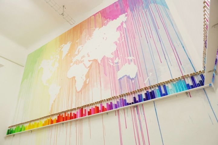 French Mademoiselle Maurice created a beautiful map of the world by dripping colorful paint, leaving the worlds seven continents in the negative. The art installation is part of her exhibition