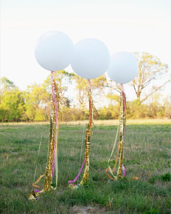 giant-balloons-with-neon-tinsel  Three 36 inch balloons embellished with neon ribbons and gold fringe the perfect backdrop for the table. These balloons are just so