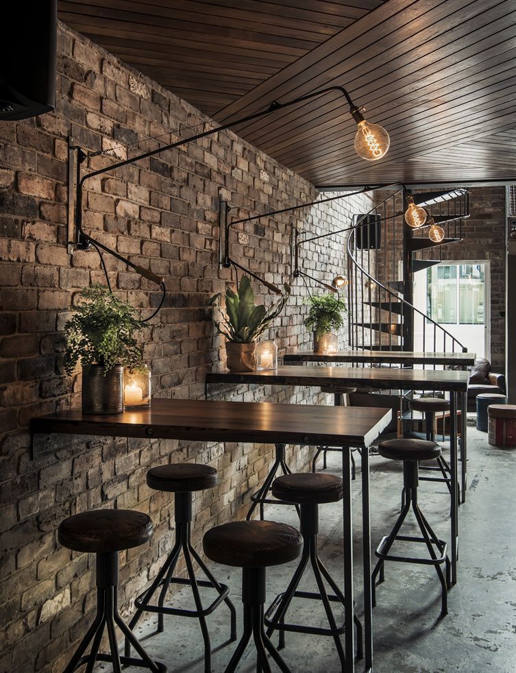 I love the decor in this cafe/ bar – particularly the wall lighting, but also the stools and those great little table decorations using old tins and glass