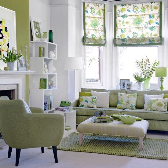 This white and green living room is alive with style. very inviting, great patterns and accents, modern furniture. Really like this