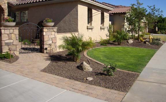 Front yard Arizona landscape design with paver driveway ribbons, paver courtyard with fountain and planter