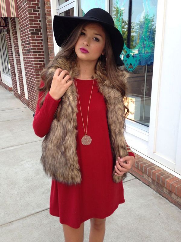 im kind of obsessed with this red dress worn under this fur vest. the floppy hat is also