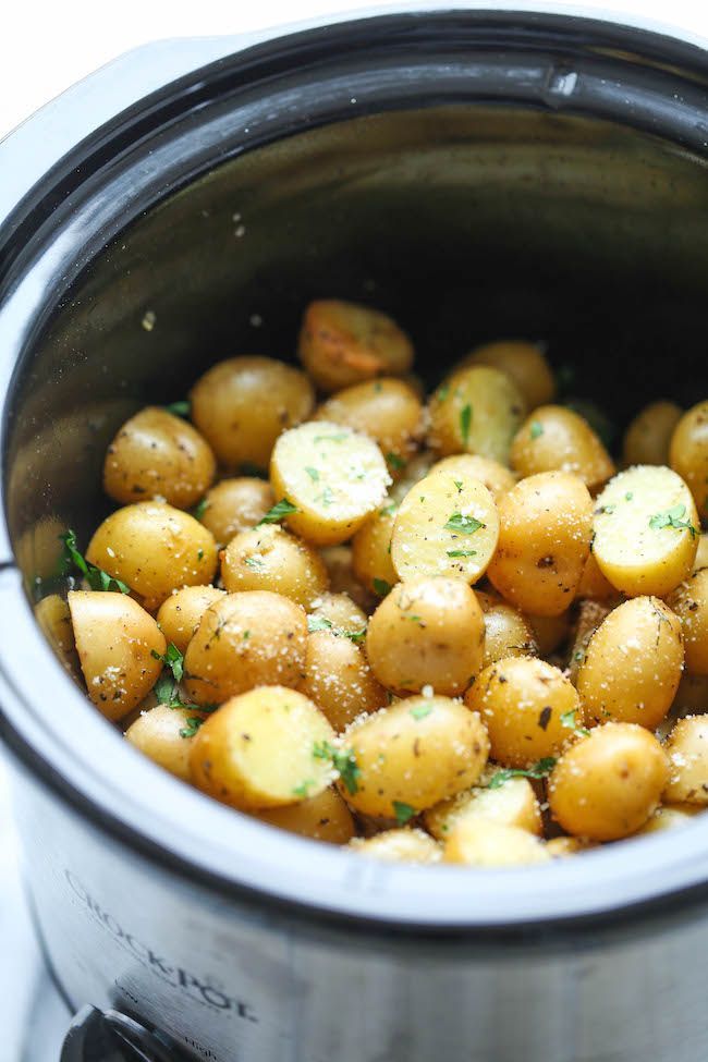 Slow Cooker Garlic Parmesan Potatoes – Crisp-tender potatoes with garlicky parmesan goodness. Its the easiest side dish you will ever make in the crockpot! from damn