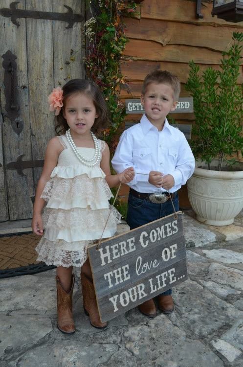 This flowergirl and ringbearer are wearing the cutest outfits for a country wedding! Also, that sign is fantastic! #countrywedding