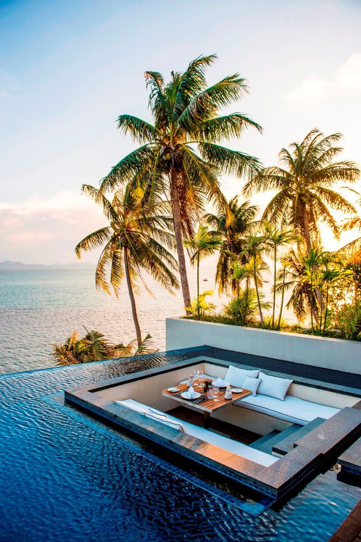 Waterfront dining surrounded by an infiniti pool at the Conrad Resort in Koh