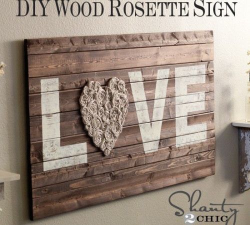 DIY Wood Wall Art with Fabric Rosettes  this would be perfect for over the