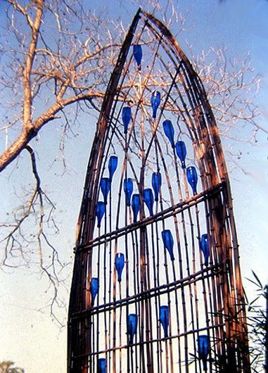 A “stained glass” window made from branches and glass bottles.  How fun would this be in the garden.