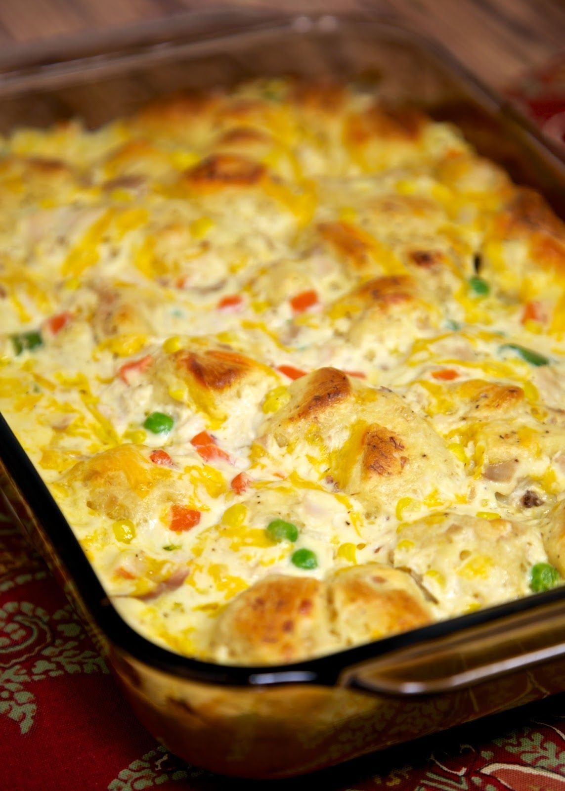 Chicken Pot Pie Bubble Up Recipe – chicken, chicken soup, sour cream, cheese, frozen vegetables and biscuits. A whole meal in one