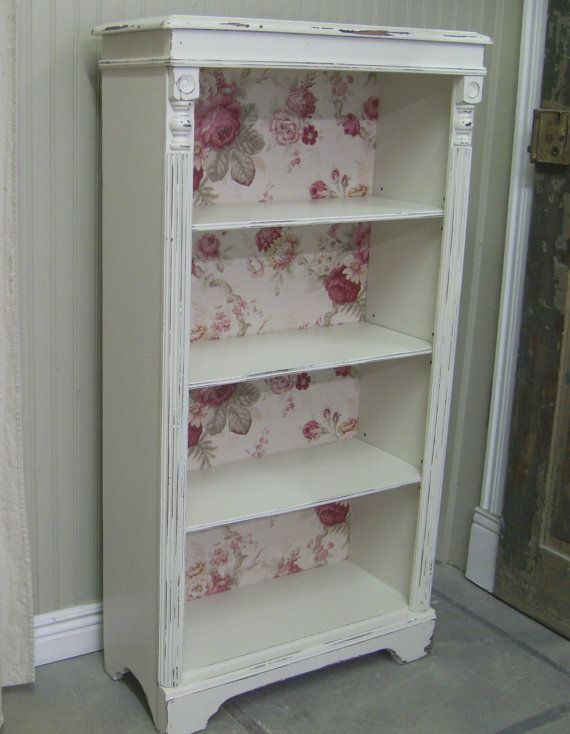 DIY wallpaper in a bookshelf!  I totally want to do this to my boring brown shelves!!