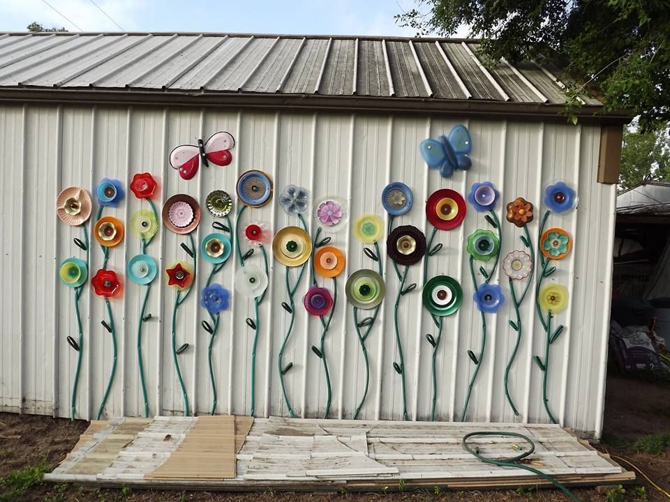 Flowers on the Outside of a Building Created With Plates and Garden Hosew