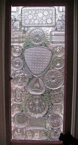 glass window with plates, lids and flat marbles glued to the surface - awesome!