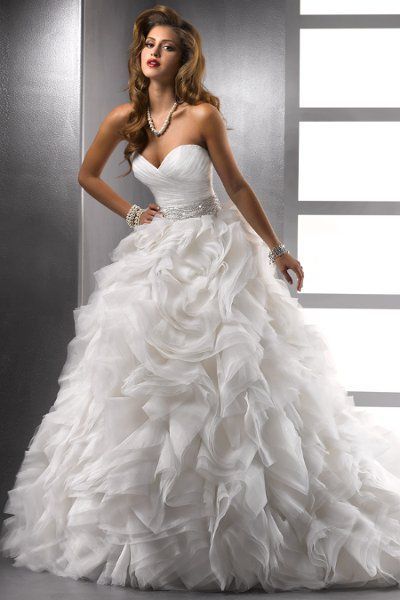 Jerrica – 72803 A grand statement of breathtaking elegance, this ball gown silhouette features a deep sweetheart neckline and