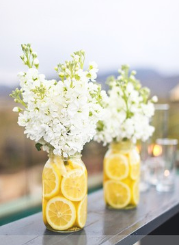 Lemons cut in half, change out the white flowers with fall colored ones and perfect party center place!