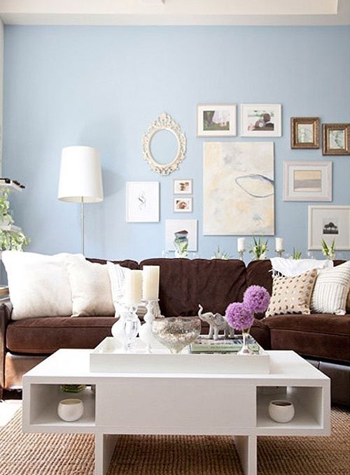 Love the blue wall with the nuetrals with the purple!  freshen up your old brown sofa…