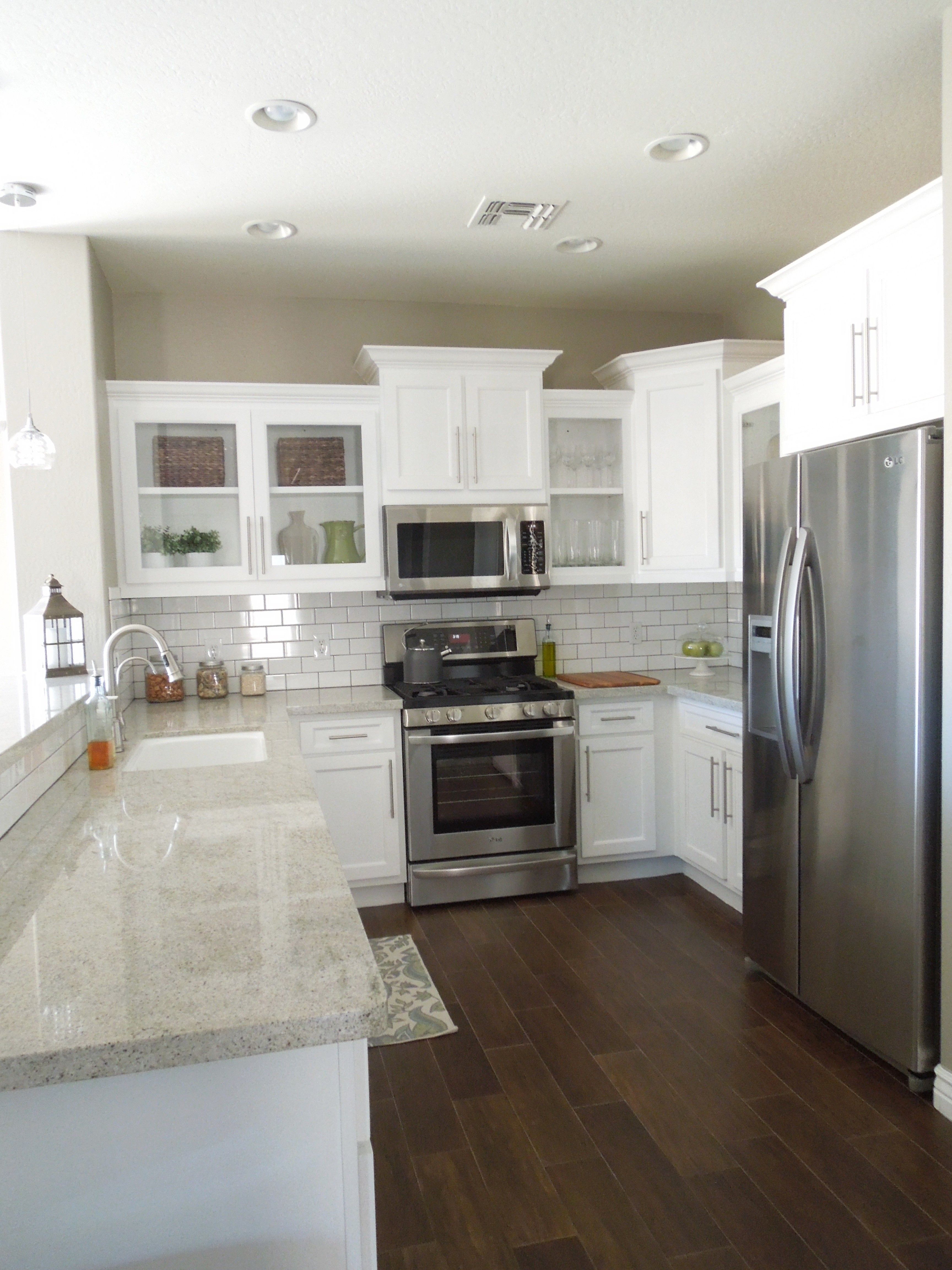Next house…white cabinets, white backsplash, gray granite and wood tile floors. Love this remodel.