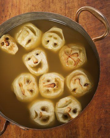 Shrunken Heads in Cider. 2 cups spiced rum, 2 gallons apple cider, 2 cans frozen lemonade concentrate, 32 whole cloves, 8 large