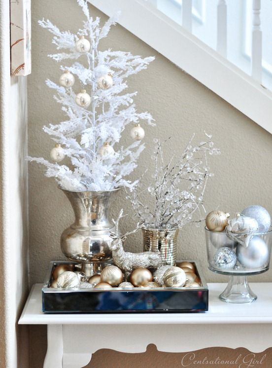 Silver and white table vignette with trees, tray of ornaments and bowl of ornaments
